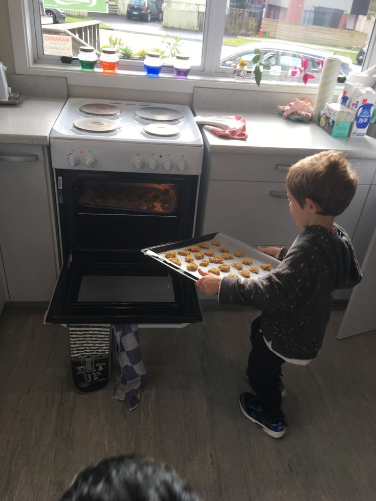 a child is using oven